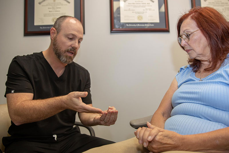 Doctor going over dental model with patient within the dental practice