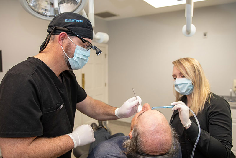 Doctor during dental procedure within the dental operating room