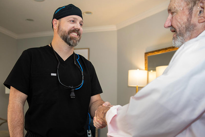 Doctor shaking hands with patient after their dental procedure