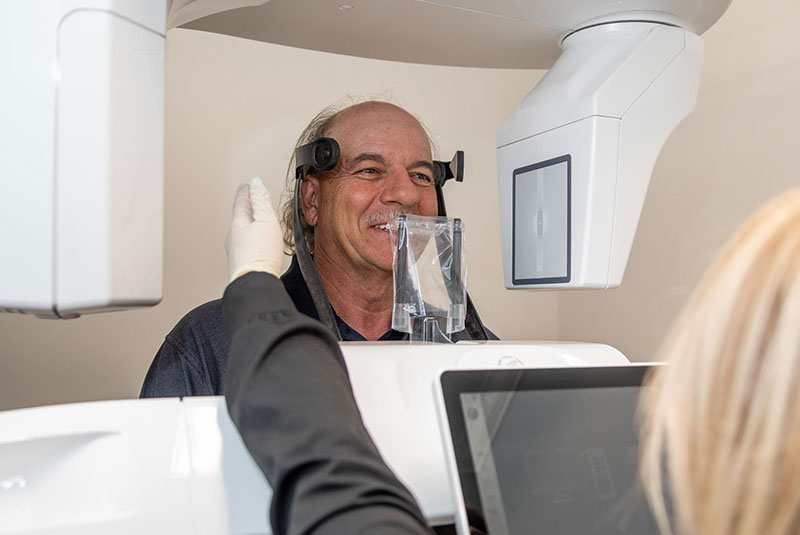 patient within 3D scanning device for dental procedure