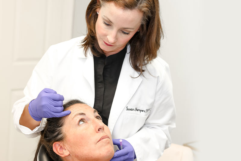 doctor with patient about to perform facial procedure